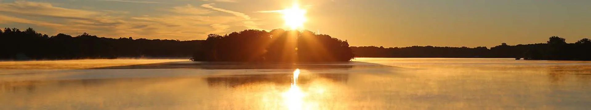Morning fog over the island on Lake Angelus